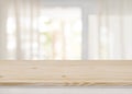 Empty table top on blurred view through abstract curtained window