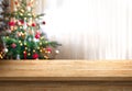 Empty table top and christmas tree in background Royalty Free Stock Photo