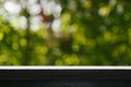 Empty table top wood table with fresh green abstract blurred trees of nature park background and summer season for product Royalty Free Stock Photo