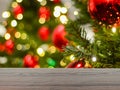 The empty table wooden board in front of the background is blurred. Perspective of brown wood in the light of a christmas tree Royalty Free Stock Photo