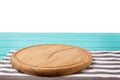 Empty tablecloth on blue wood table and pizza cutting board isolated on white background. Selective focus. Place for food. Top Royalty Free Stock Photo