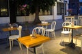 Empty tables with candles in street cafe on the central street of Varna in the evening