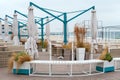 Empty tables and chairs of a restaurant on a terrace overlooking the sea. Cafe with sea view closed for quarantine or winter. Nice Royalty Free Stock Photo