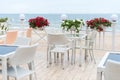 Empty tables and chairs of a restaurant on a terrace overlooking the sea. Cafe with sea view. Nice place to eat with seaview. Royalty Free Stock Photo