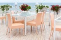 Empty tables and chairs of a restaurant on a terrace overlooking the sea. Cafe with sea view. Nice place to eat with seaview. Royalty Free Stock Photo