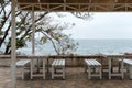 Empty tables and chairs of a restaurant on a terrace overlooking the sea. Cafe with sea view. Nice place to eat with seaview. Royalty Free Stock Photo