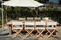 Empty tables, chairs and umbrellas in the garden for BBQ Party Royalty Free Stock Photo