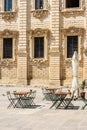 Empty tables of a closed coffee shop in the main baroque square of Lecce, Apulia Italy