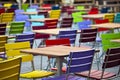 Empty tables and coloured chairs in a street