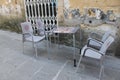 Empty tables on a sloping street