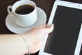 empty tablet and a cup of coffee on the black desk Royalty Free Stock Photo