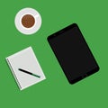 Empty tablet and a cup of coffee on the desk isolated on green background Royalty Free Stock Photo