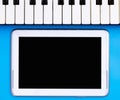 Empty tablet screen with music keyboard for music concept Royalty Free Stock Photo