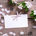 Empty tag and tender apple tree flowers on aged vintage wooden b Royalty Free Stock Photo