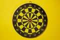 The empty target for a darts - dartboard isolated on yellow background