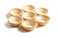 Empty tartlet shells isolated on white. Group of crispy mini tart shells for portable desserts Royalty Free Stock Photo
