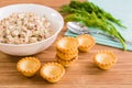 Empty tartlets and ready salad from canned fish and eggs Royalty Free Stock Photo
