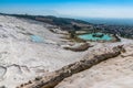 The empty Tavertine Cascades in Pamukkale, Turkey and a man-made channel formed to repair damage to the formation