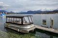 Empty taxi boat moored to a wooden pier on lake Lucerne. Town of Lucerne, Switzerland Royalty Free Stock Photo