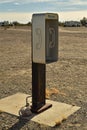 Empty telephone booth in desert outdated technology