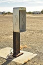 Empty telephone booth in desert outdated technology