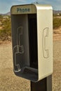 Empty telephone booth in desert outdated technology