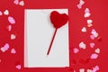 Empty template for romantic letters on red background. Red pen with fur heart shape.