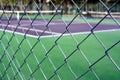 Empty tennis court behind wire fence Royalty Free Stock Photo