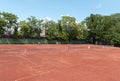 Empty tennis court on sunny summer day. View from above of red clay tennis court. Outdoor sports playground. Copy space Royalty Free Stock Photo