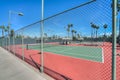 Empty tennis court under a blue cloudless sky Royalty Free Stock Photo