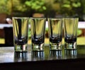 Empty tequila vodka shot glasses on outdoor bar counter