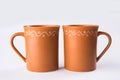 Empty terracotta mug or brown clay coffee cup or jar or drinking glass