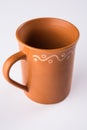 Empty terracotta mug or brown clay coffee cup or jar or drinking glass