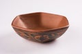 Empty terracotta serving bowl or brown clay soup bowl on white