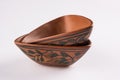 Empty terracotta serving bowl or brown clay soup bowl on white