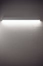 Empty textured white wall with modern long light. Royalty Free Stock Photo