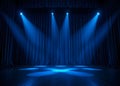 Empty theater stage with dramatic blue spotlights and dark curtains Royalty Free Stock Photo