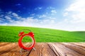 Empty tiles at wooden table with landscape, grass and blue sky. Clean, idyllic, landscape with sun. Concept of time to travel and Royalty Free Stock Photo