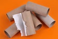 Empty toilet paper roll cartons close-up on orange background