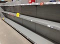 Empty toilet paper shelves in supermarket after panic buying due to outbreaking coronavirus, translation:`There is no stock availa