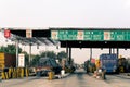 Empty toll booth on indian highway with FASTag callout on the headboard and traffic waiting