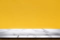 Empty white marble table with yellow concrete textured wall background Royalty Free Stock Photo