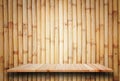 Empty top wooden shelves and bamboo wall background Royalty Free Stock Photo