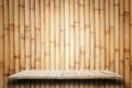 Empty top wooden shelves and bamboo wall background Royalty Free Stock Photo