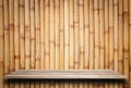 Empty top wooden shelves and bamboo wall background Royalty Free Stock Photo