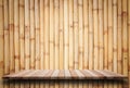 Empty top wooden shelves and bamboo wall background Royalty Free Stock Photo