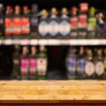 Empty top of wooden table with blurred counter bar and bottles B Royalty Free Stock Photo
