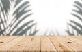 Empty top wooden table with blurred tree shadow on concrete wall background
