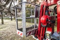 An empty tracked basket for gardeners with helmet. Mobile aerial work platform