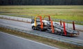 An empty tractor-trailer truck with a semi-trailer car transporter drives along the highway in the summer against the Royalty Free Stock Photo